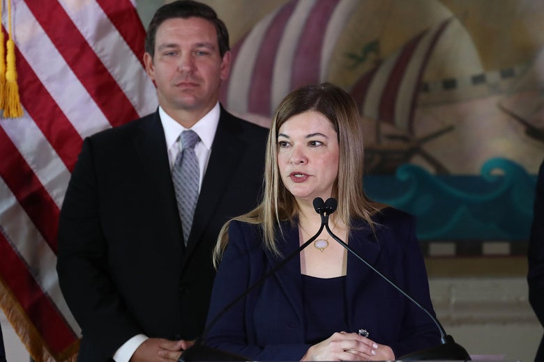 Judge Barbara Lagoa delivers a speech while Florida Gov. Ron DeSantis looks on.