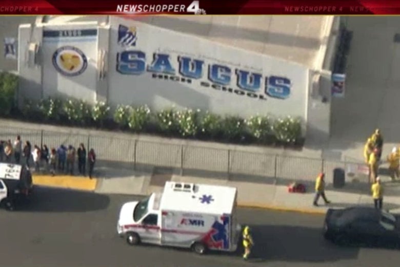 News footage of police and emergency vehicles and students lined up outside Saugus High School.