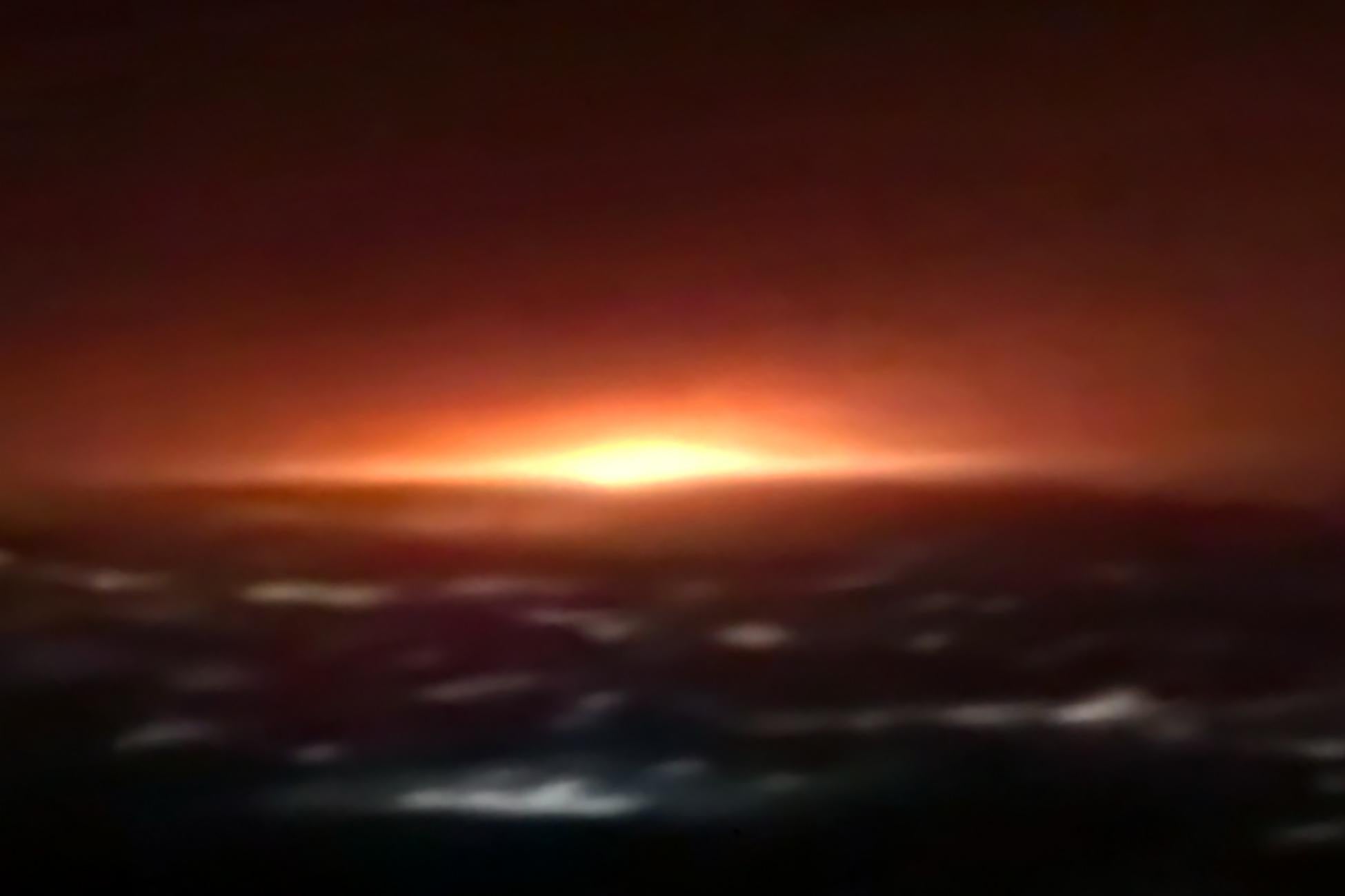 Blurry screen capture of an explosion in the night sky.
