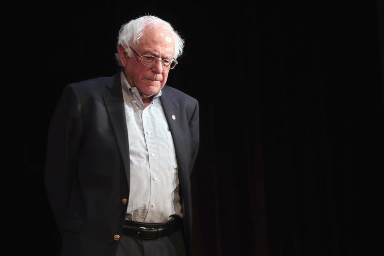 Bernie Sanders looks downward.