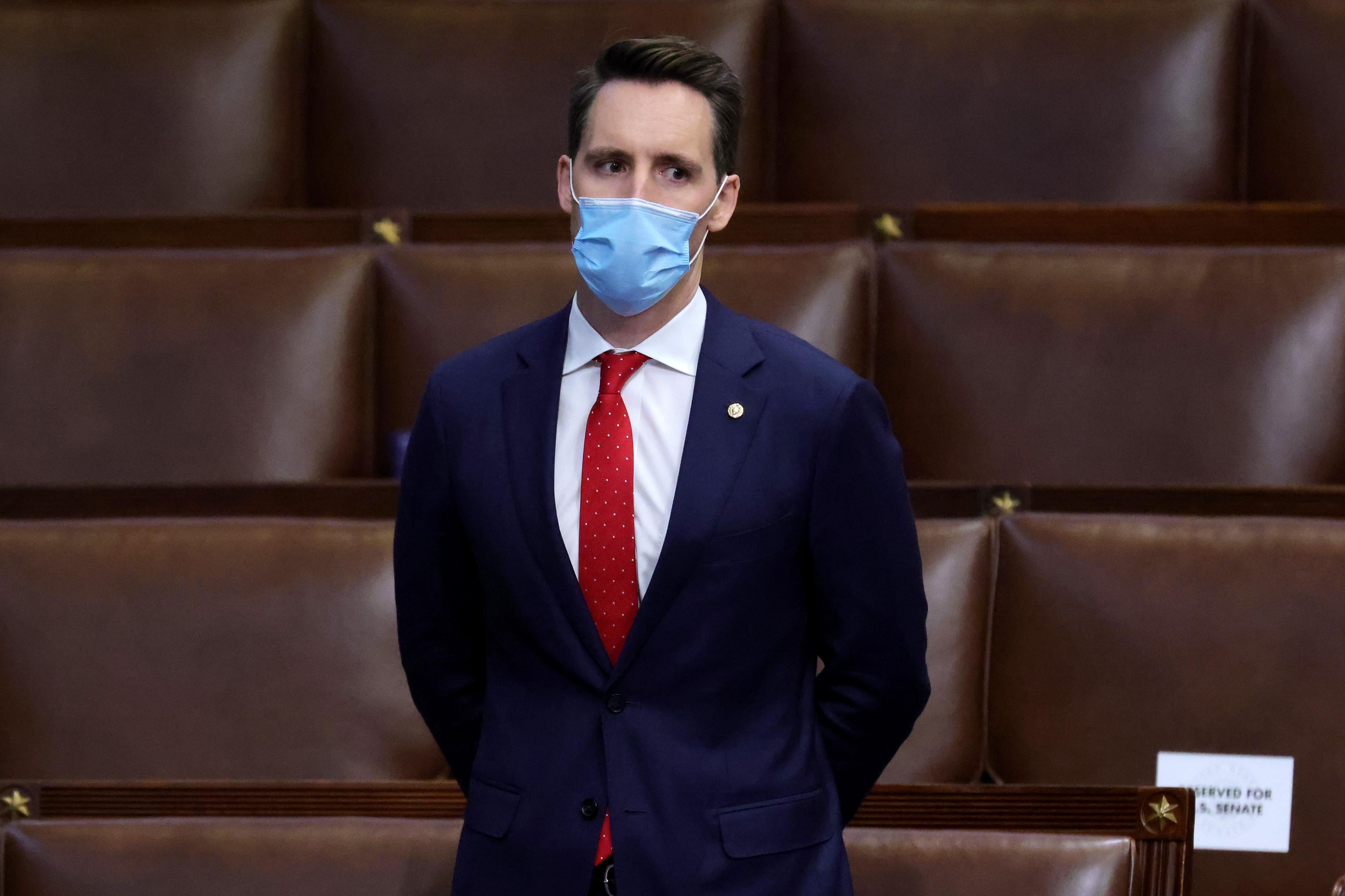 WASHINGTON, DC - JANUARY 06: Sen. Josh Hawley (R-MO) stands in the House Chamber during a reconvening of a joint session of Congress on January 06, 2021 in Washington, DC. Members of Congress returned to the House Chamber after being evacuated when protesters stormed the Capitol and disrupted a joint session to ratify President-elect Joe Biden's 306-232 Electoral College win over President Donald Trump. (Photo by Win McNamee/Getty Images)