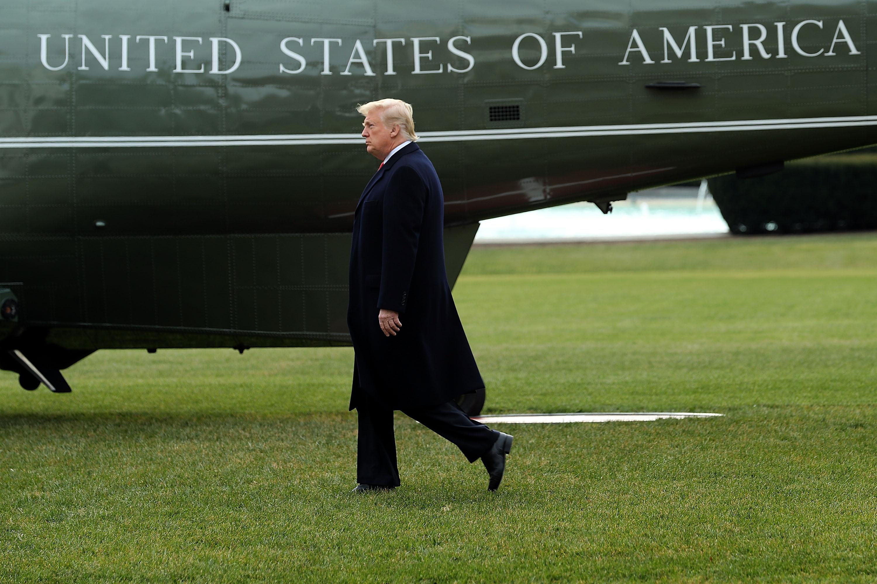 President Donald Trump walks across the South Lawn before boarding Marine One and leaving the White House December 22, 2017 in Washington, DC. Trump is leaving Washington to spend the Christmas holiday at his Mar-a-lago Estate in Palm Beach, Florida. 