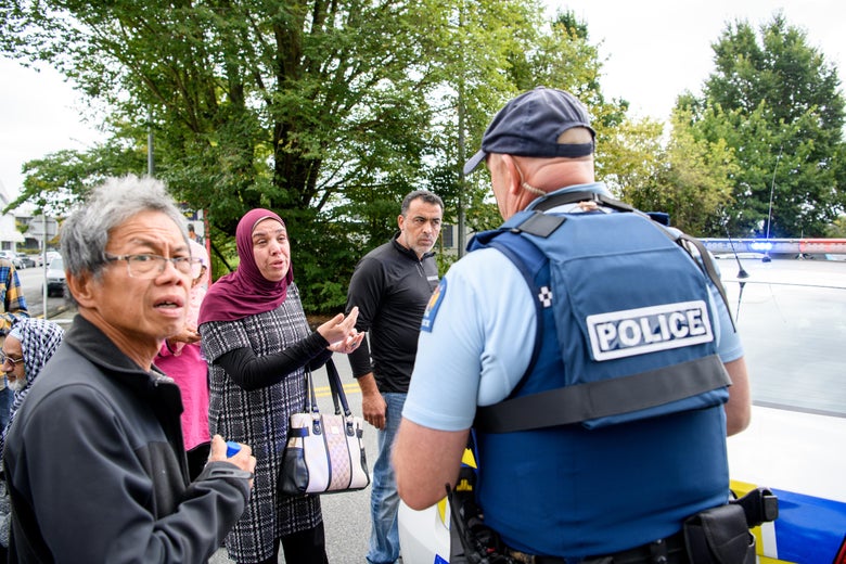 Members of the public speak to police in front of the Masjd al-Noor mosque in Christchurch, New Zealand.