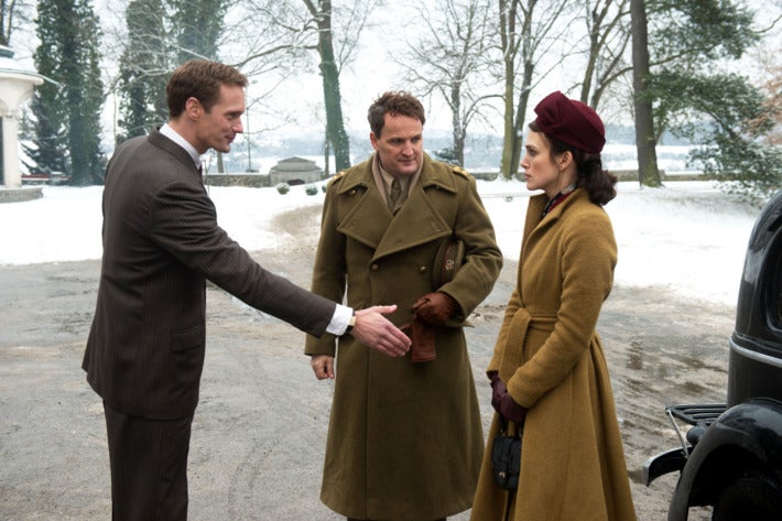 Alexander Skarsgård, Jason Clarke, and Kiera Knightley stand outside in winter.