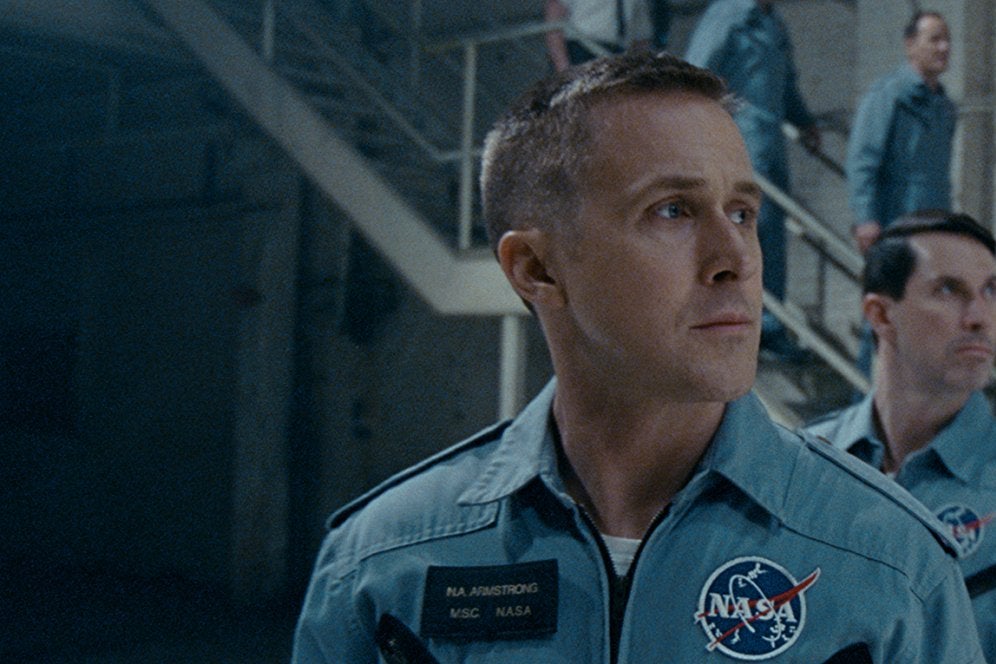 Ryan Gosling, Patrick Fugit, Shawn Eric Jones, and others wear uniforms with the NASA logo on them.