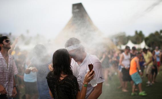 A couple dances as they are hosed with water at the Do Lab during the Coachella Valley Music and Arts Festival in Indio, California April 13, 2012. 