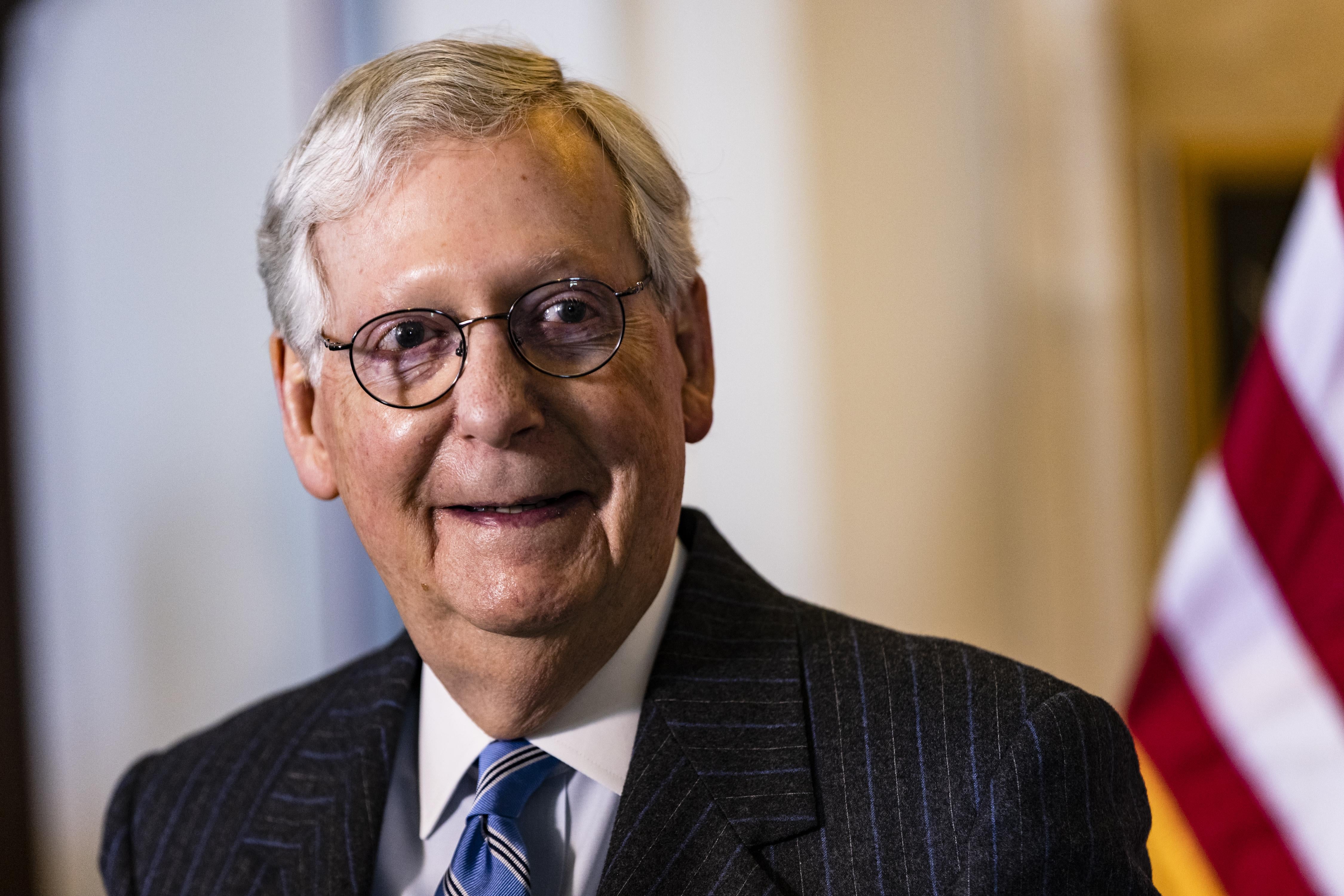 Mitch McConnell smiles.