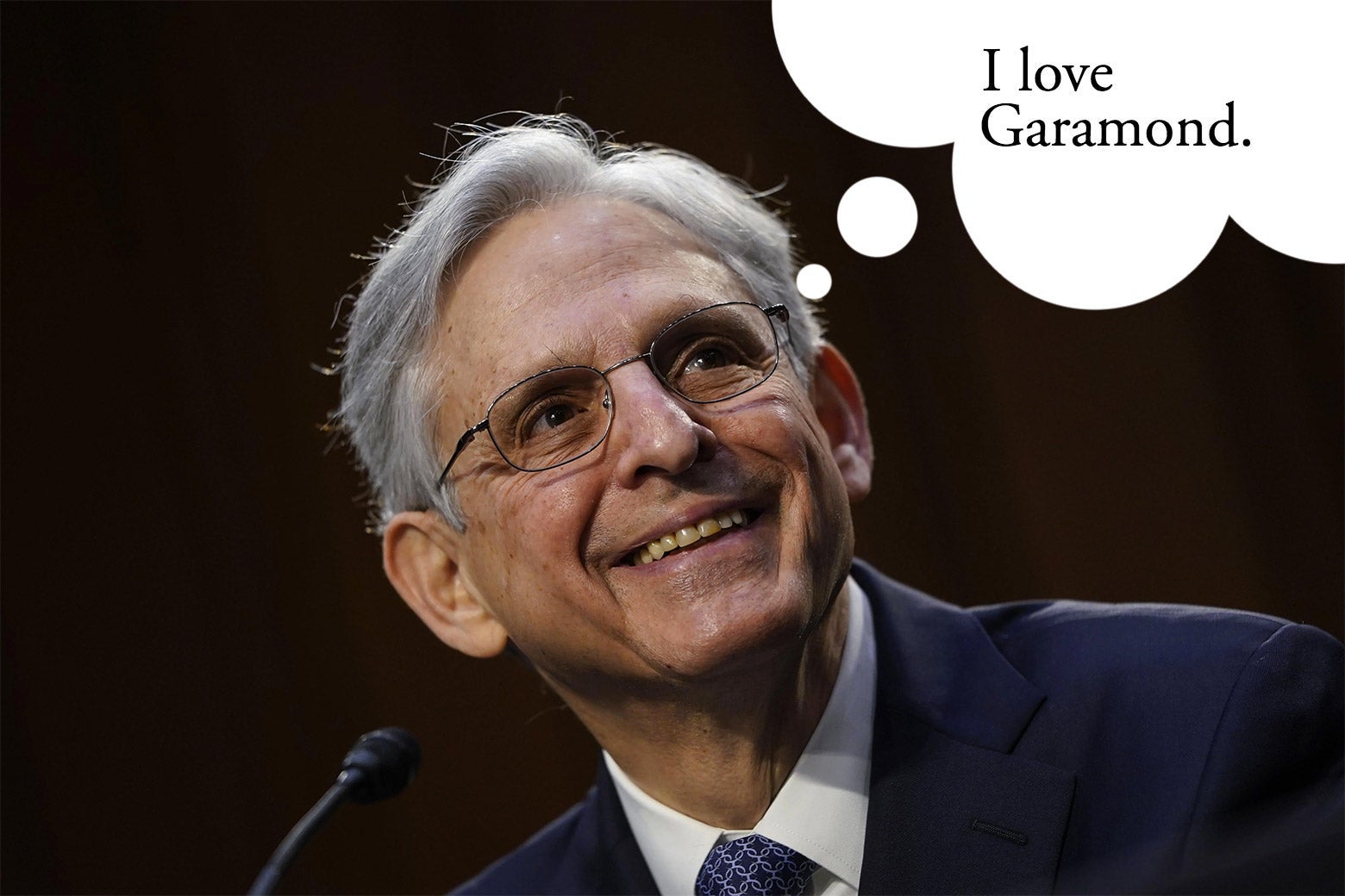 Merrick Garland smiling in front of a microphone
