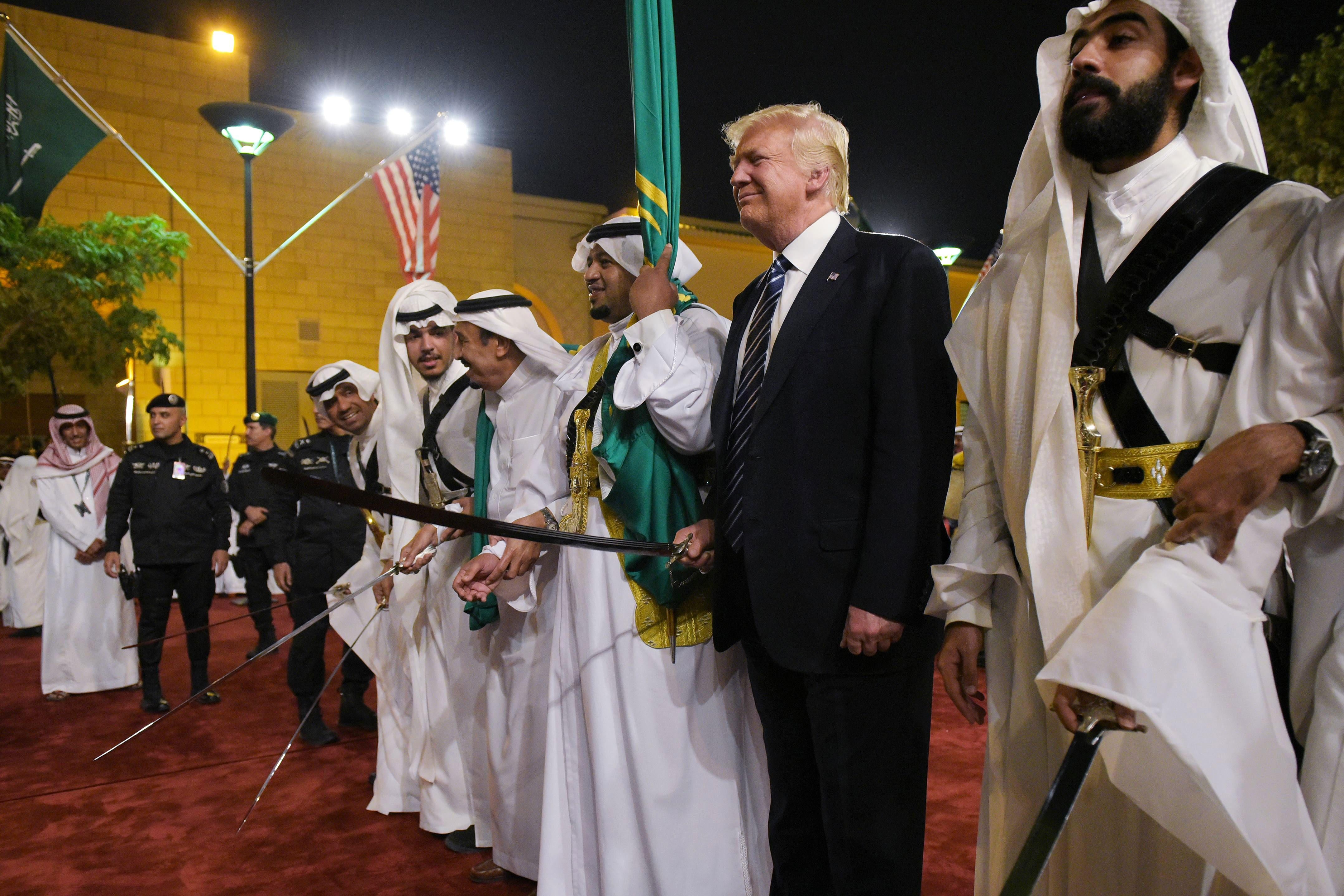 U.S. President Donald Trump joins dancers with swords at a welcome ceremony ahead of a banquet at the Murabba Palace in Riyadh on May 20, 2017. 