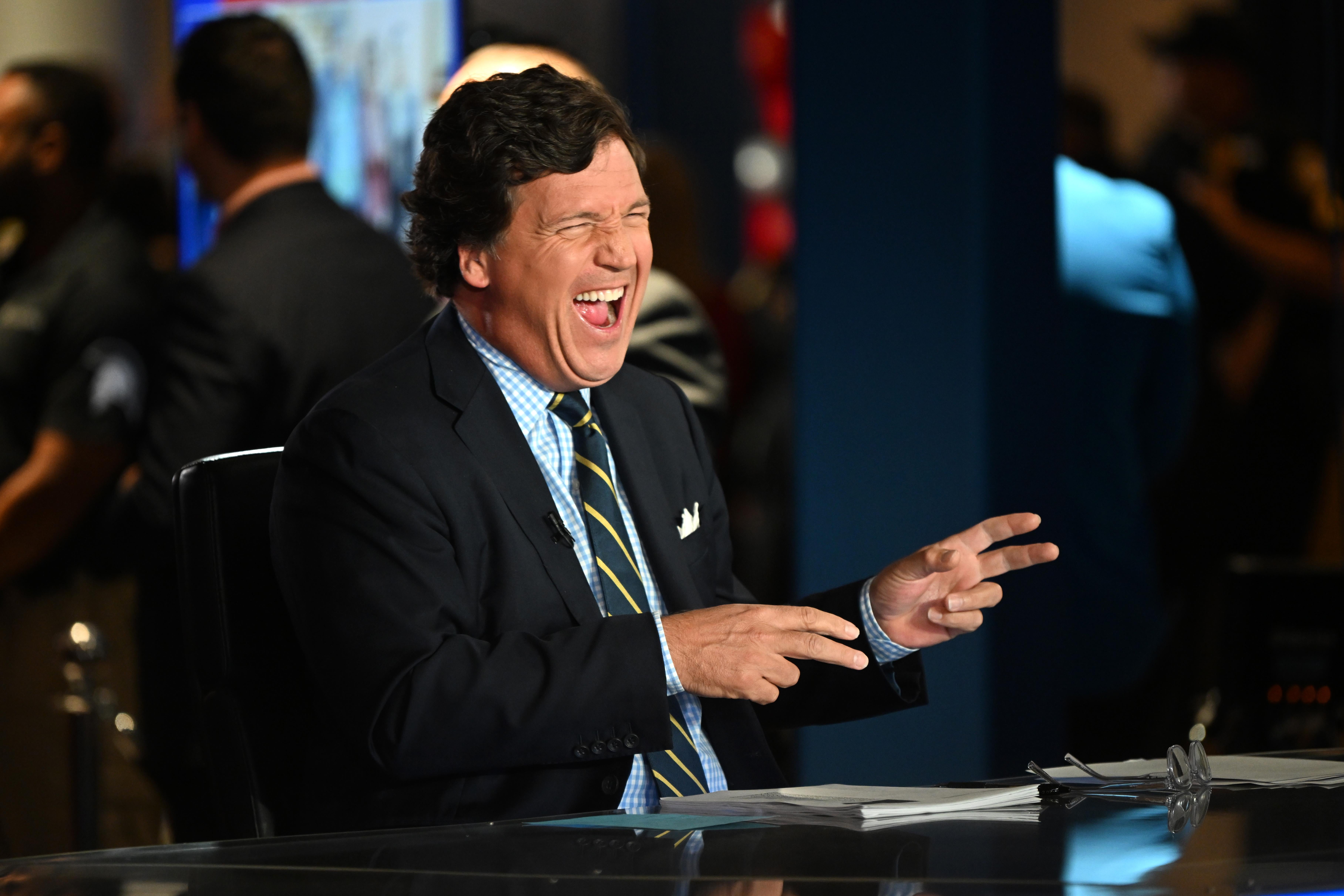 Tucker Carlson laughing apparently uproariously. 