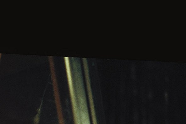 Deborah Reed grimaces in a rearview mirror