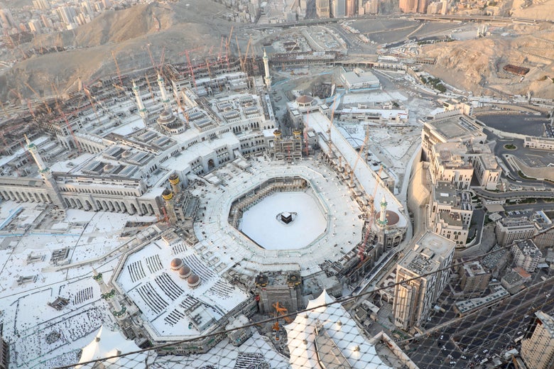 An aerial view shows an empty white-tiled area surrounding the Kaaba in Mecca’s Grand Mosque.
