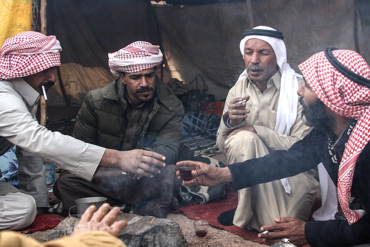 Megreh race track caretaker Eleyyan (left) serves one his friends, Musallem (right), a cup of tea as the discuss everyday matters.