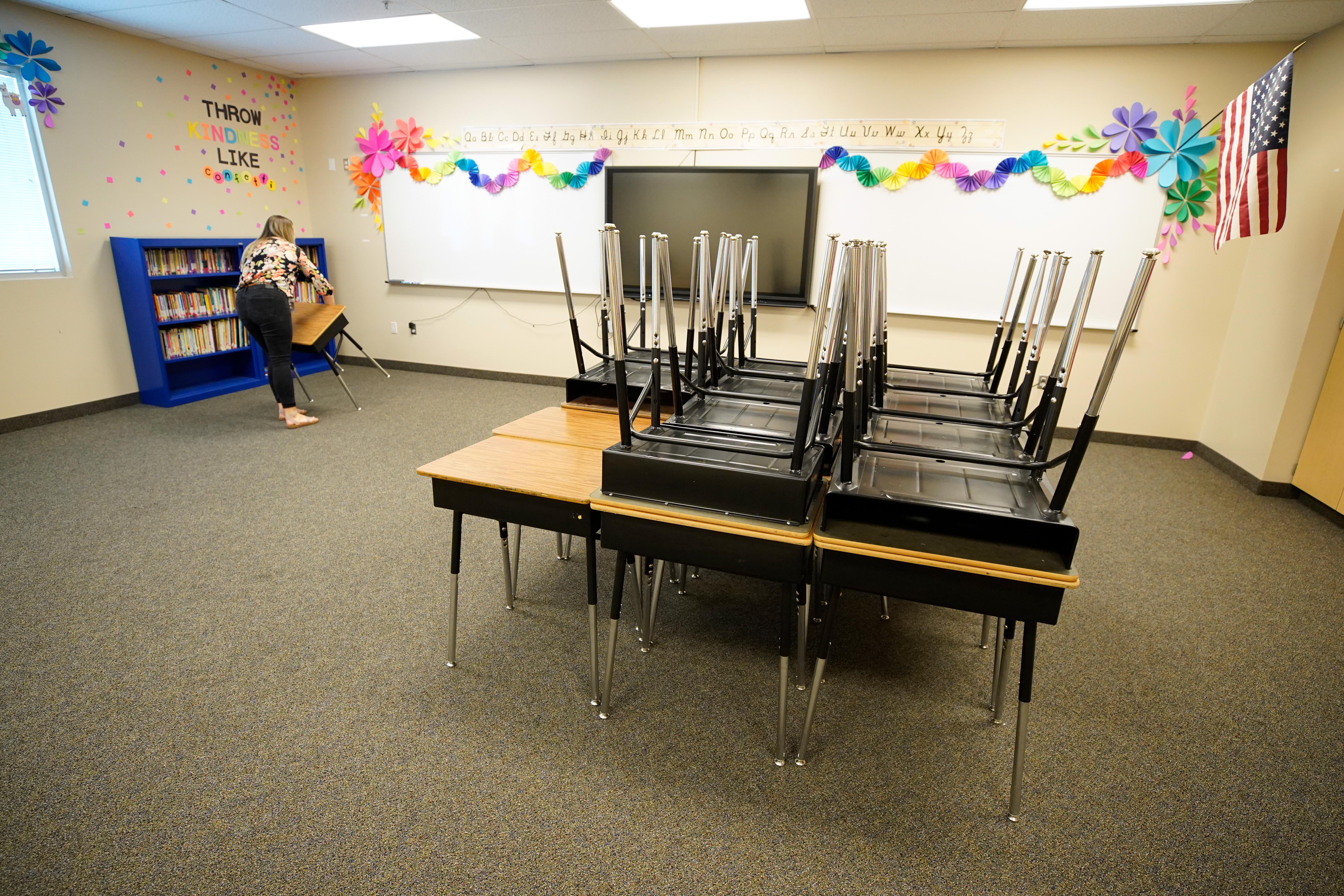 A teacher starts to reset up her classrooms with new rules on social distancing at Freedom Preparatory Academy as they begin to prepare to restart school after it was closed in March due to COVID-19 on August 5, 2020 in Provo, Utah.