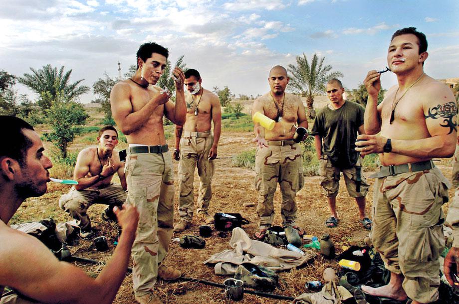 U.S. Marines take a break to shave in front of one of Saddam Hussain's presidential palaces the day Tikrit fell from Republican Guard rule, April 15, 2003.