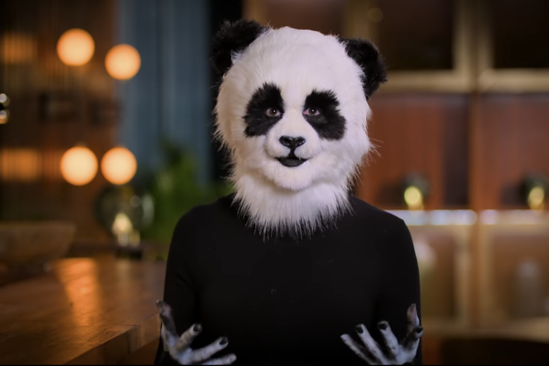 Woman in black shirt with a panda mask.