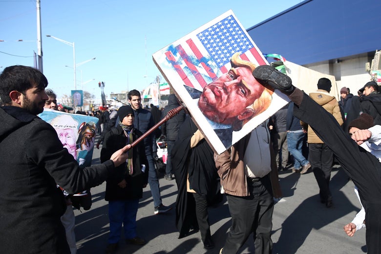 An Iranian kicks a placard of the U.S. President Donald Trump, during the commemoration of the 41st anniversary of the Islamic revolution in Tehran, Iran February 11, 2020.