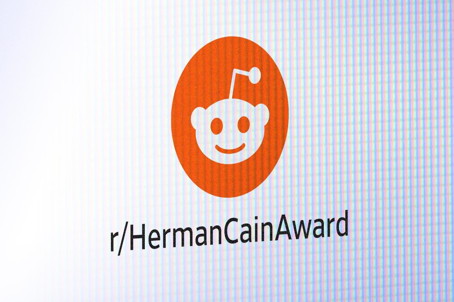 A screen depicts the Reddit logo above a line of text reading "r/HermanCainAward."