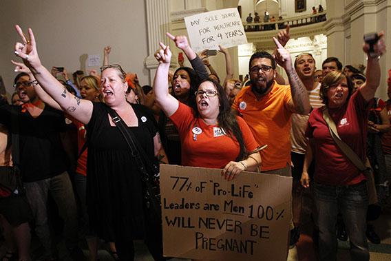 Abortion rights activists demonstrate outside the floor of the House after the HB2 bill restricting abortion rights passed in Austin, Texas July 9, 2013.