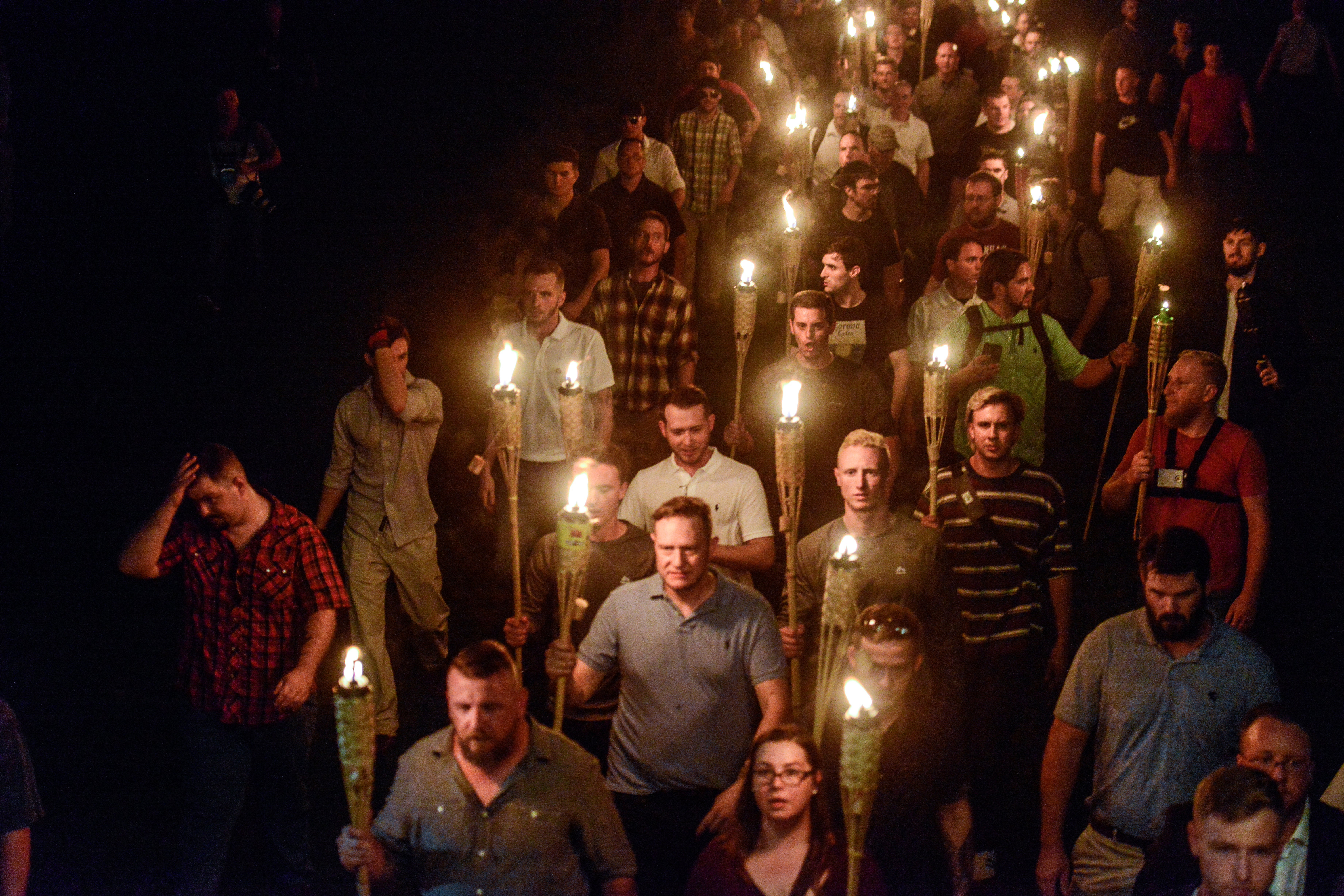 White supremacist demonstrators march with tiki torchers the night before the Unite the Right rally in Charlottesville, VA in Aug 2017.