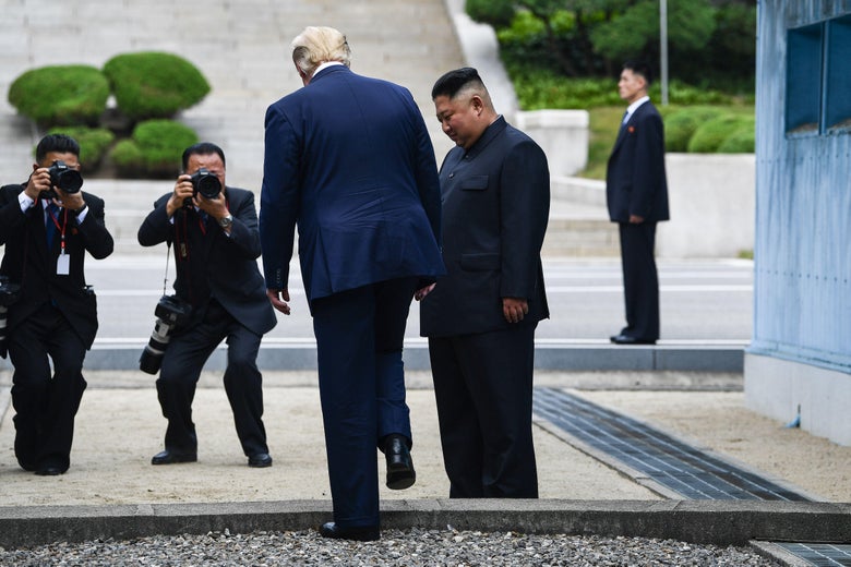 President Donald Trump steps into the northern side of the Military Demarcation Line that divides North and South Korea, as North Korea's leader Kim Jong Un looks on, in the Joint Security Area (JSA) of Panmunjom in the Demilitarized zone (DMZ) on June 30, 2019.