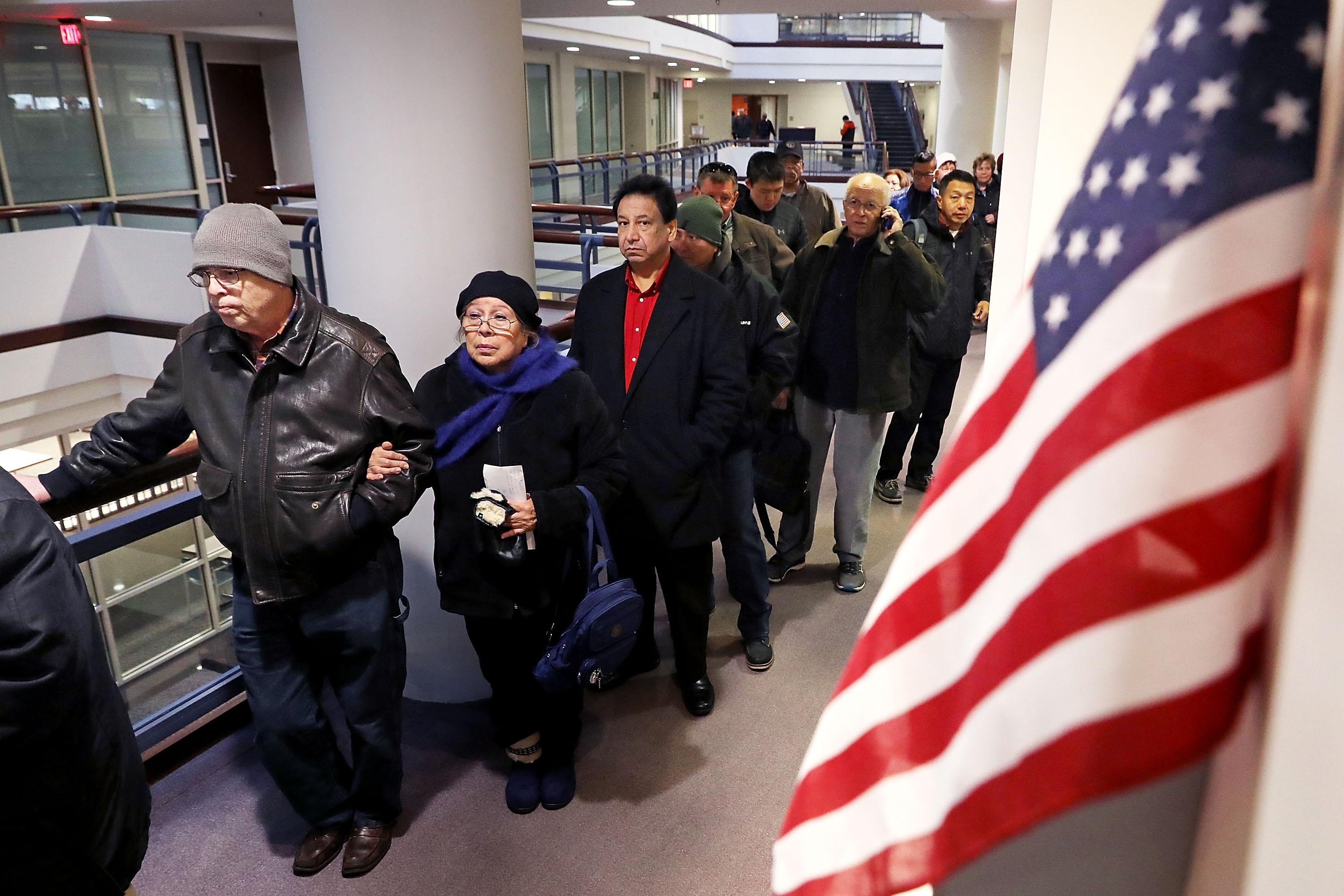 FAIRFAX, VA - DECEMBER 28:  Residents wait in line to pay taxes at the Fairfax County Government Center December 28, 2017 in Fairfax, Virginia. Many people are pre-paying their 2018 property taxes before the end of the calendar year in an attempt to blunt the effects of the new Republican tax law's $10,000 cap on deductions for state and local taxes that will disproportionately affect higher-tax, Democratic-leaning states.   (Photo by Chip Somodevilla/Getty Images)
