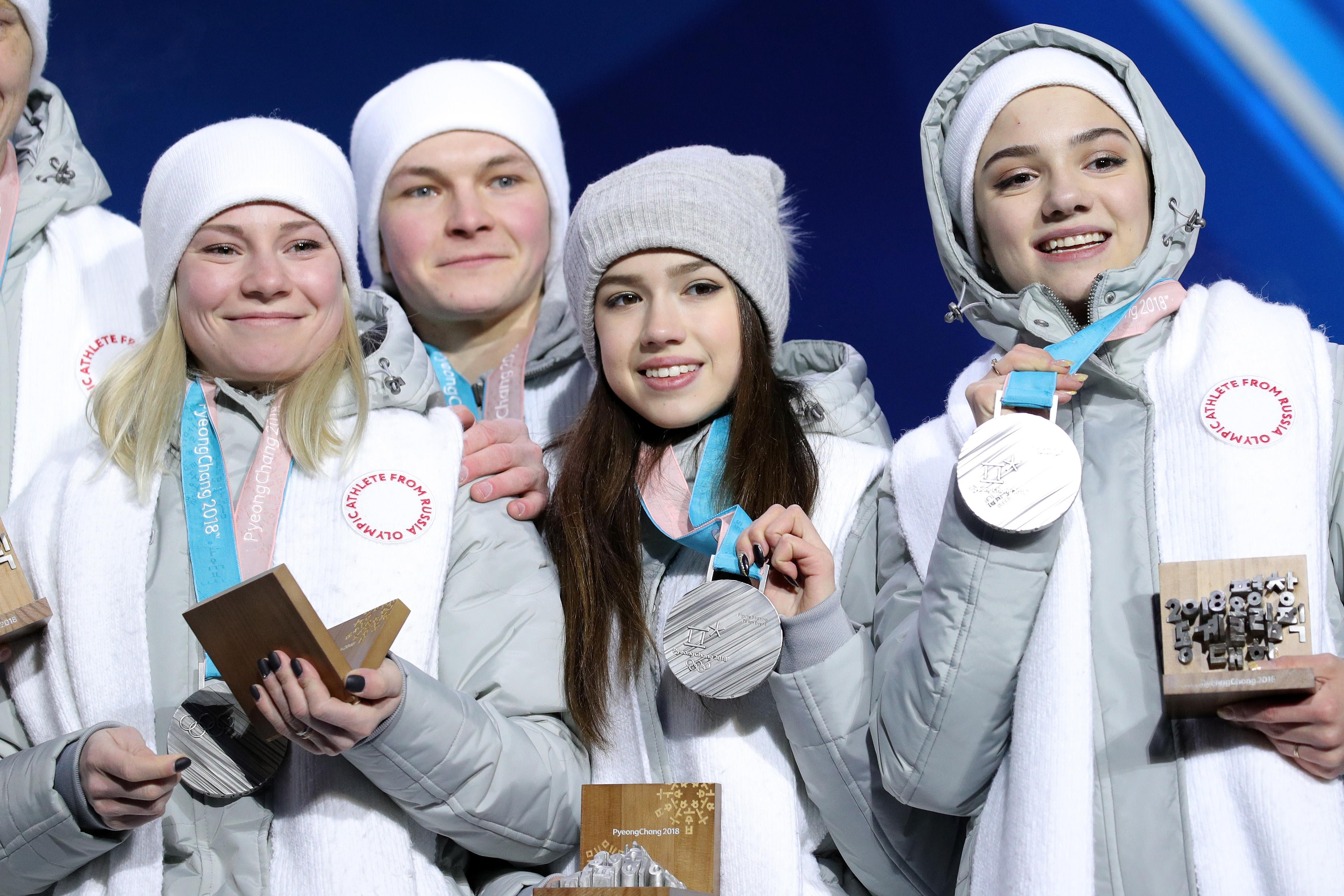 Four Olympic Athletes from Russia display the silver medals they won in the team figure skating event at the Pyeongchang Olympics.