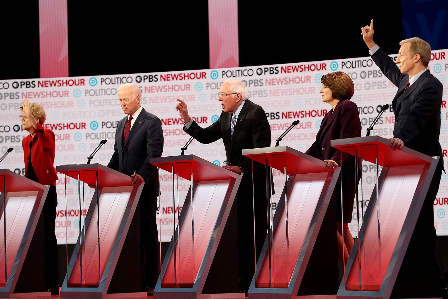 Bernie Sanders speaks as Elizabeth Warren, Joe Biden, and Tom Steyer react during the Democratic presidential primary debate.