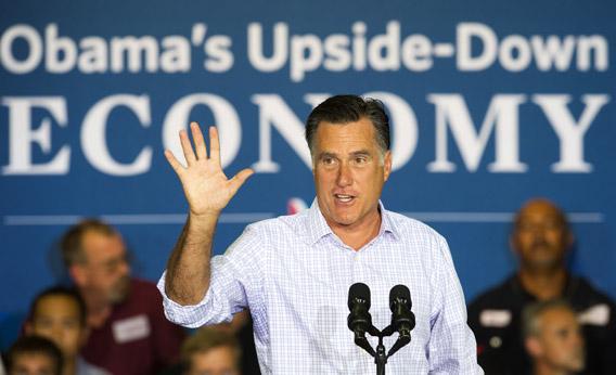 Mitt Romney waves to the crowd before delivering remarks on the economy