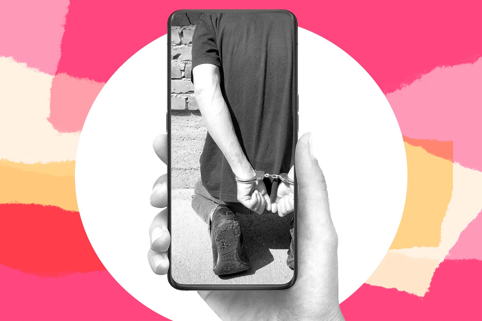 A person holding on a phone. On the phone is a picture of a man kneeling in handcuffs.