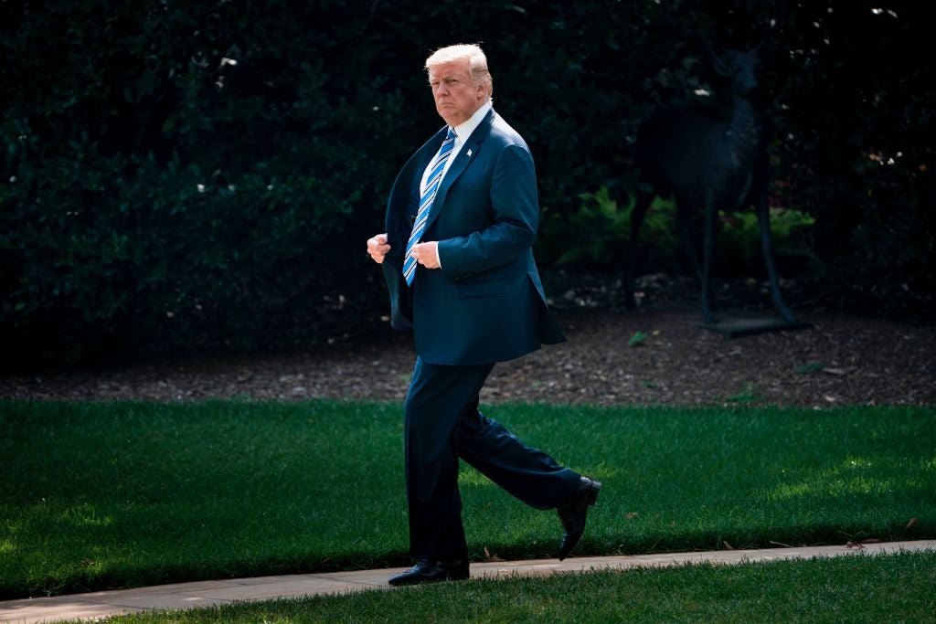 Donald Trump walks across the White House lawn.