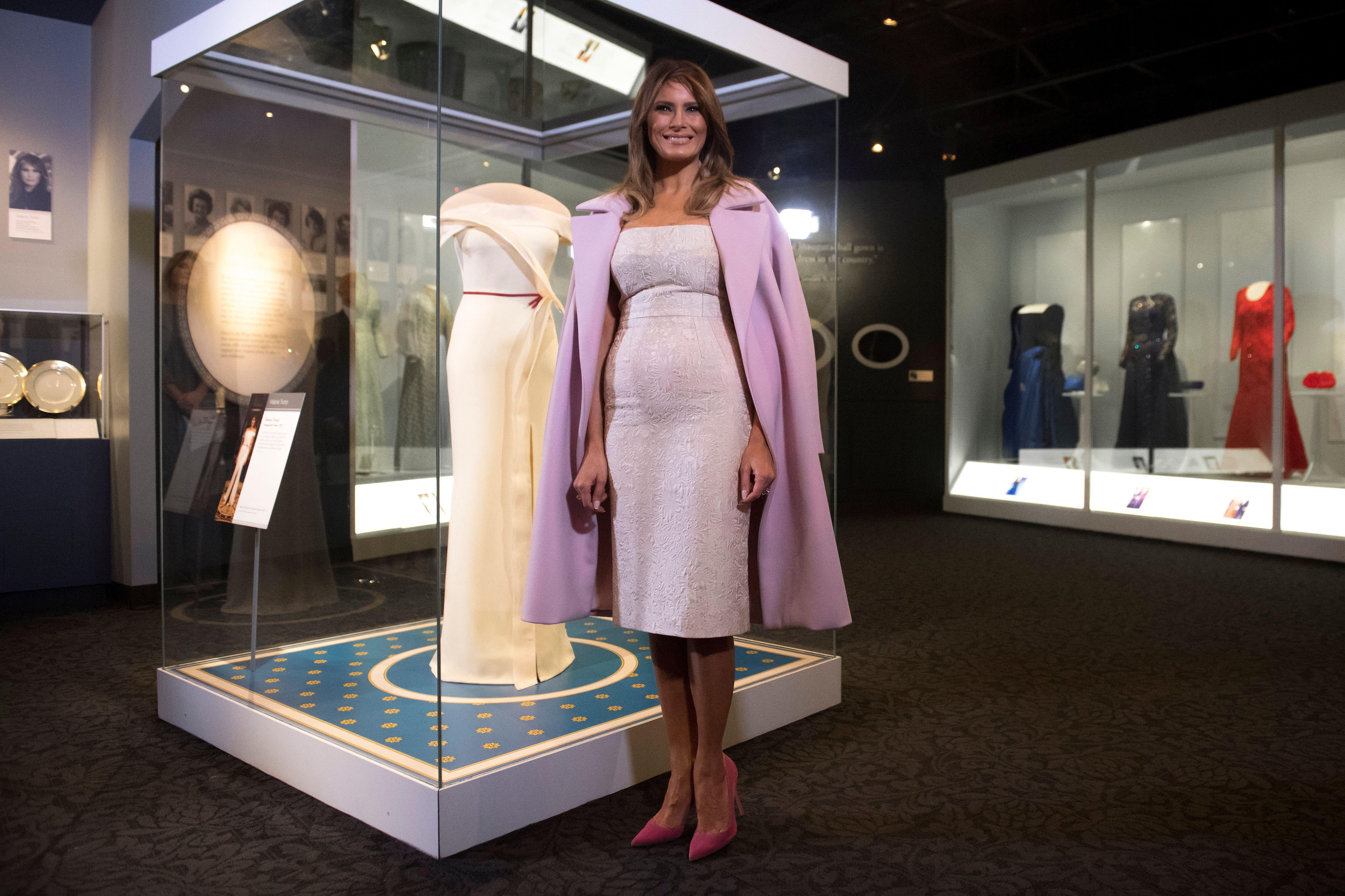 US First Lady Melania Trump stands alongside the gown she wore to the 2017 inaugural balls as she donates the dress to the Smithsonian's First Ladies Collection at the Smithsonian National Museum of American History in Washington, DC, October 20, 2017. / AFP PHOTO / SAUL LOEB        (Photo credit should read SAUL LOEB/AFP/Getty Images)