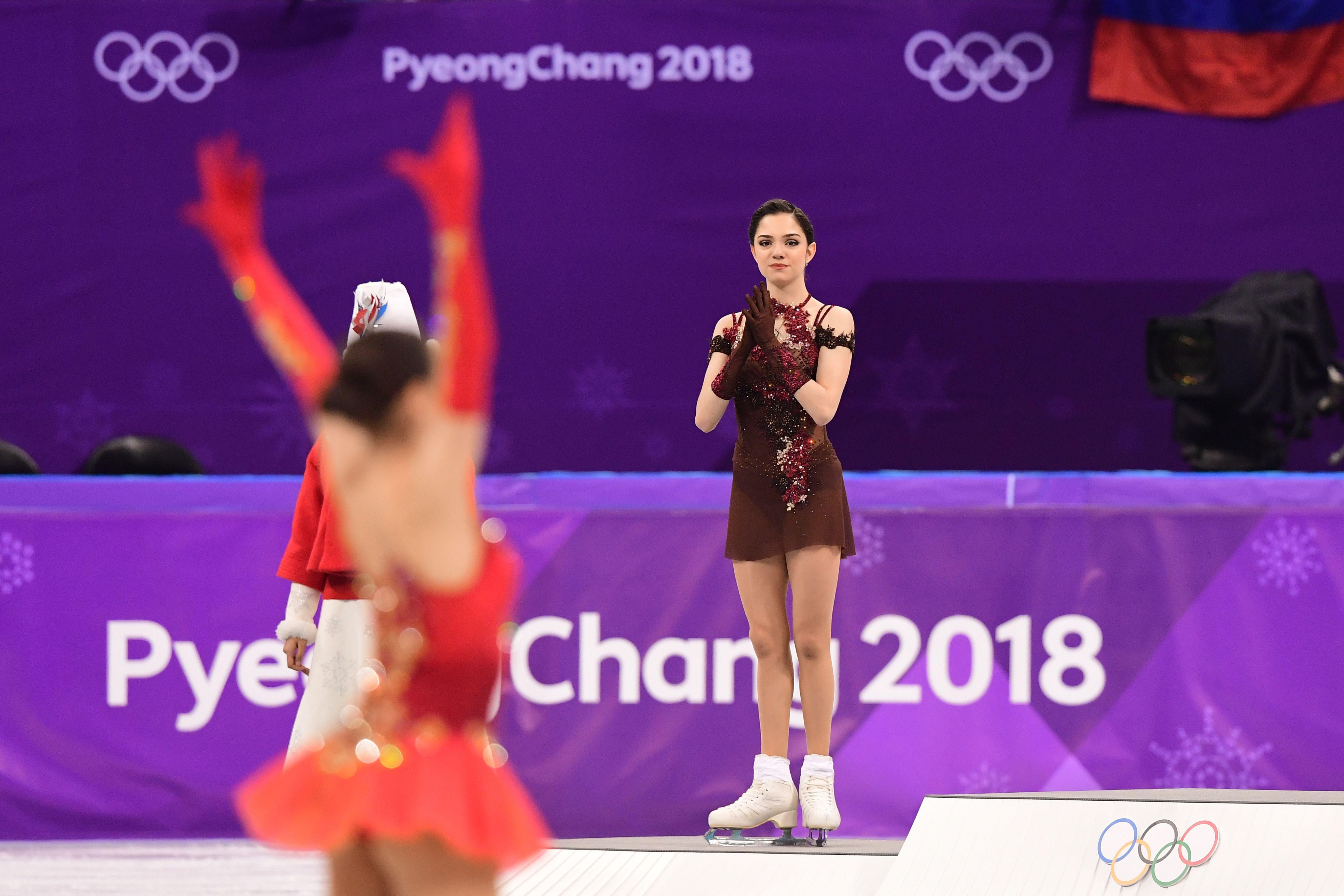 Gold medalist Russia’s Alina Zagitova celebrates as silver medalist Russia’s Evgenia Medvedeva claps.