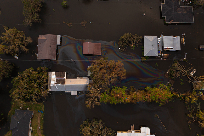 Aerial view of oil seeping out of homes into the surrounding flood water.