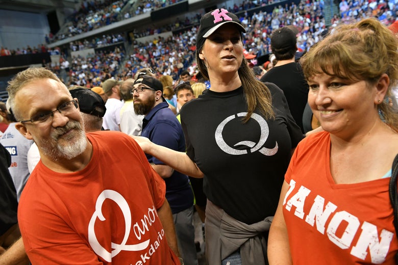 Members of QAnon await the arrival of President Donald Trump for a political rally in Wilkes-Barre, Pennsylvania on Aug. 2.