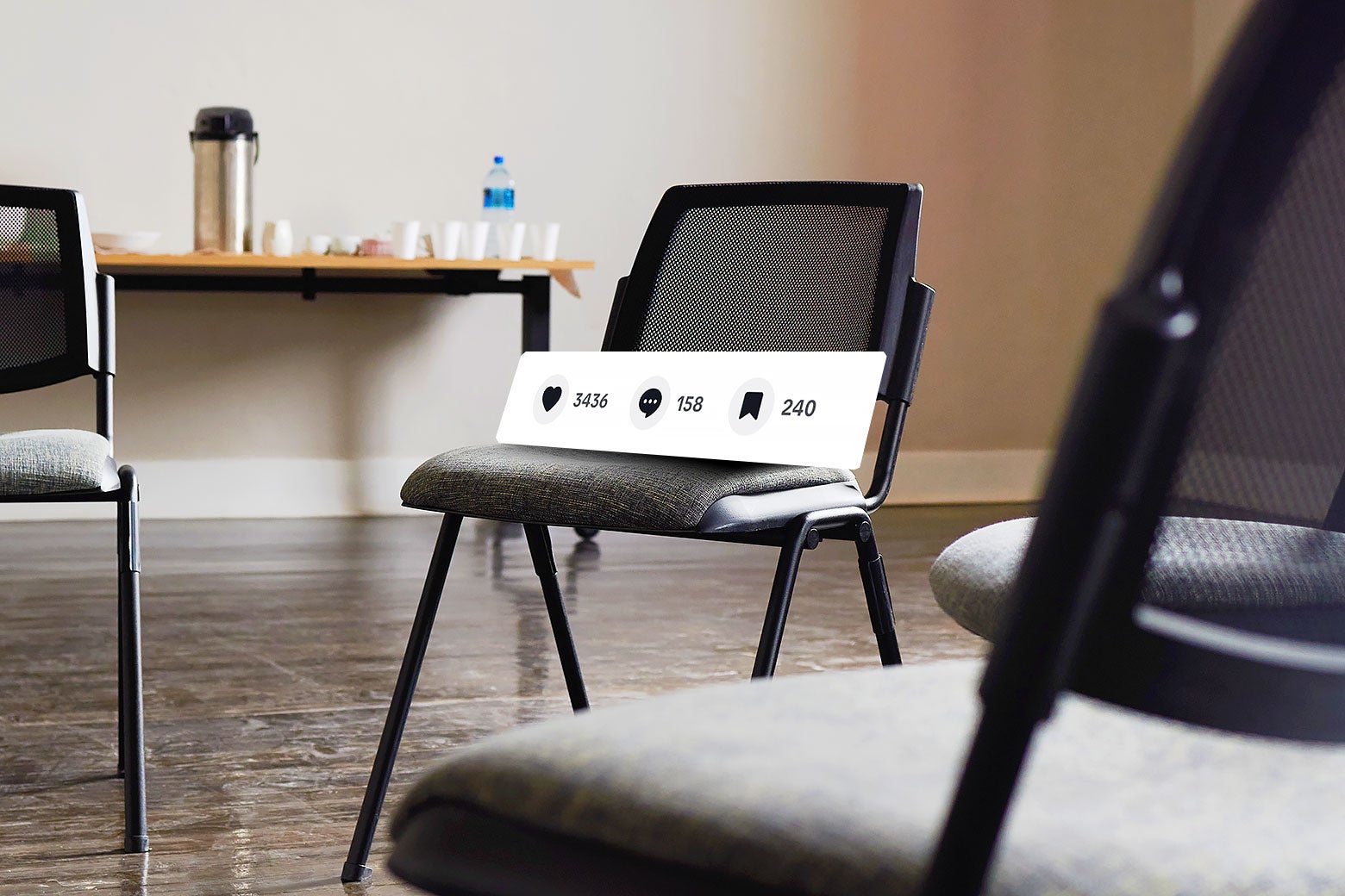 A circle of chairs at an AA meeting. One of the chairs has a large board displaying TikTok likes, comments, and bookmark counts.