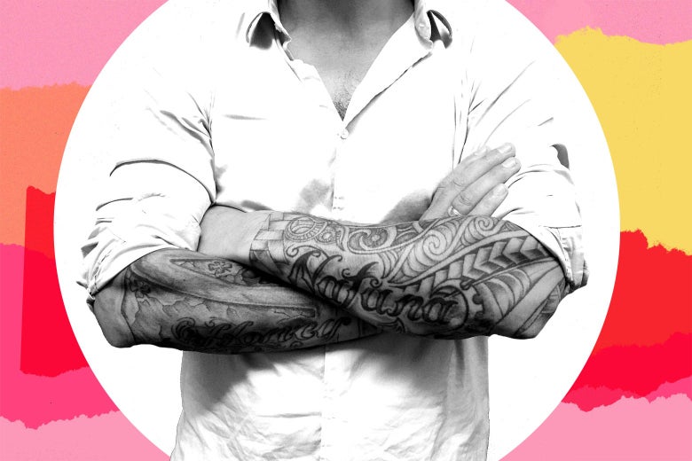 A man crossing his heavily tattooed forearms.