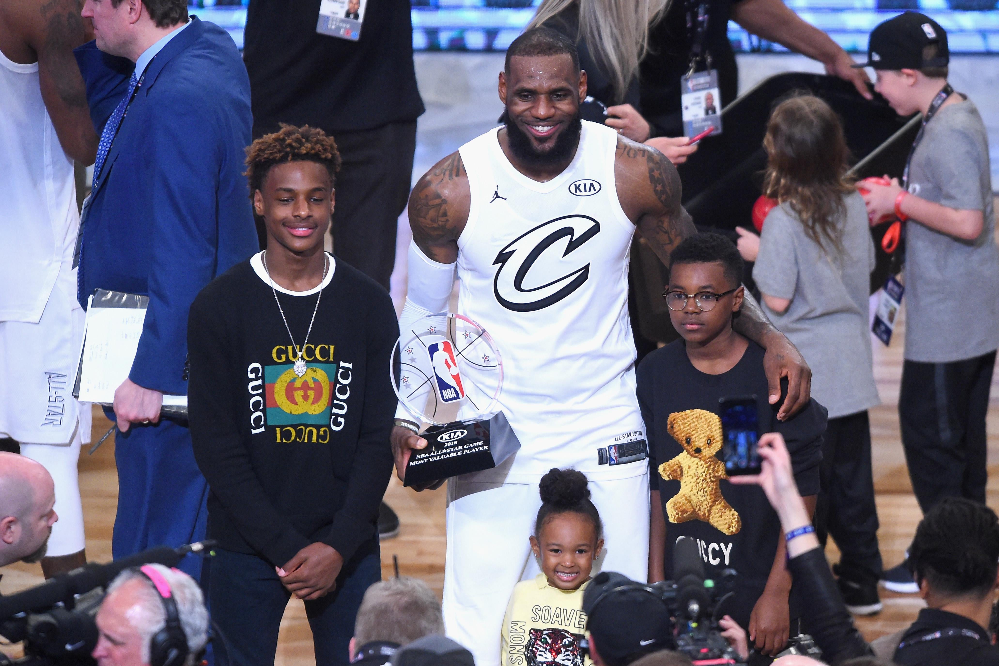 LeBron James Jr., LeBron James, Zhuri James, and Bryce Maximus James pose for a photo on the court after the All-Star Game.