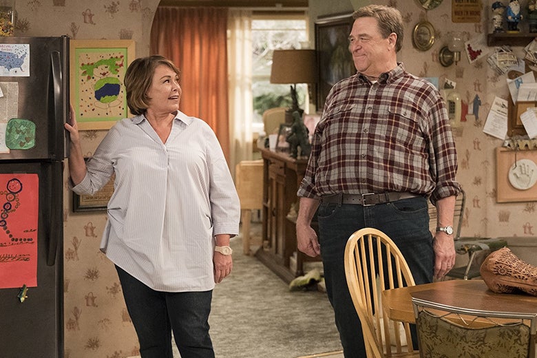 Roseanne Barr and John Goodman smile at each other on the set of the rebooted Roseanne.