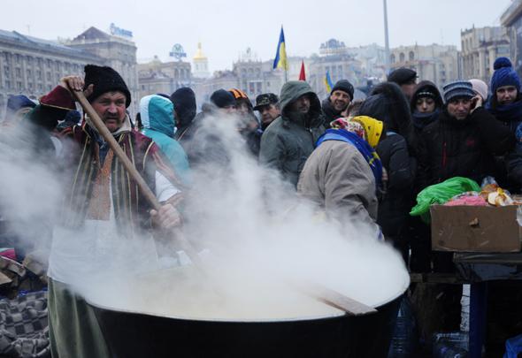 A man in a cossack costume cooks a traditional dish called "cossack kulish".