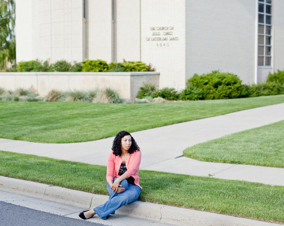 Catherine Spruill, an African American Mormon, sits in front of her Ward in West Jordan, Utah. The LDS church has a complicated history with African Americans. Their doctrine did not allow black men to hold the priesthood until 1978.