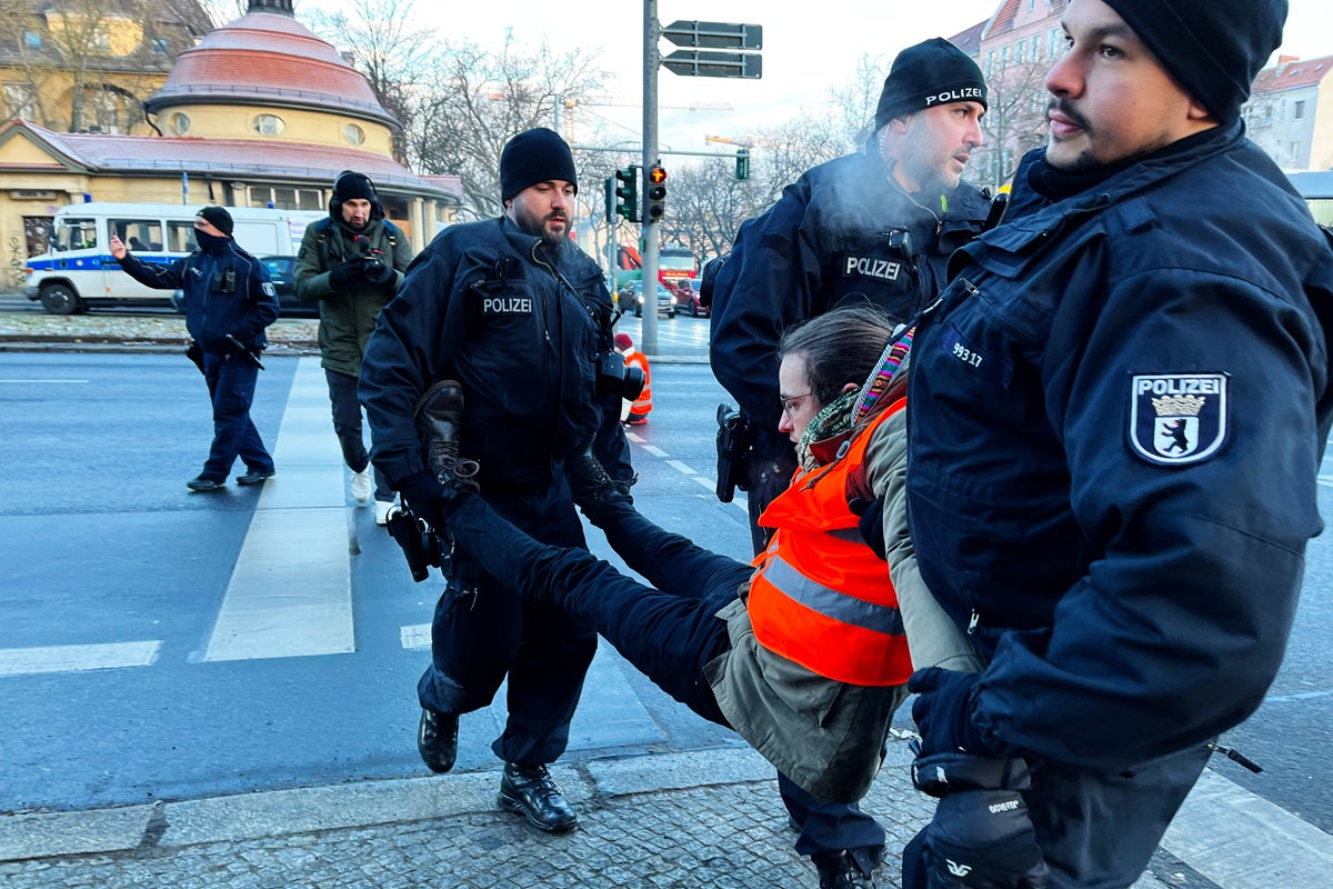 A man is carried out of an intersection by police