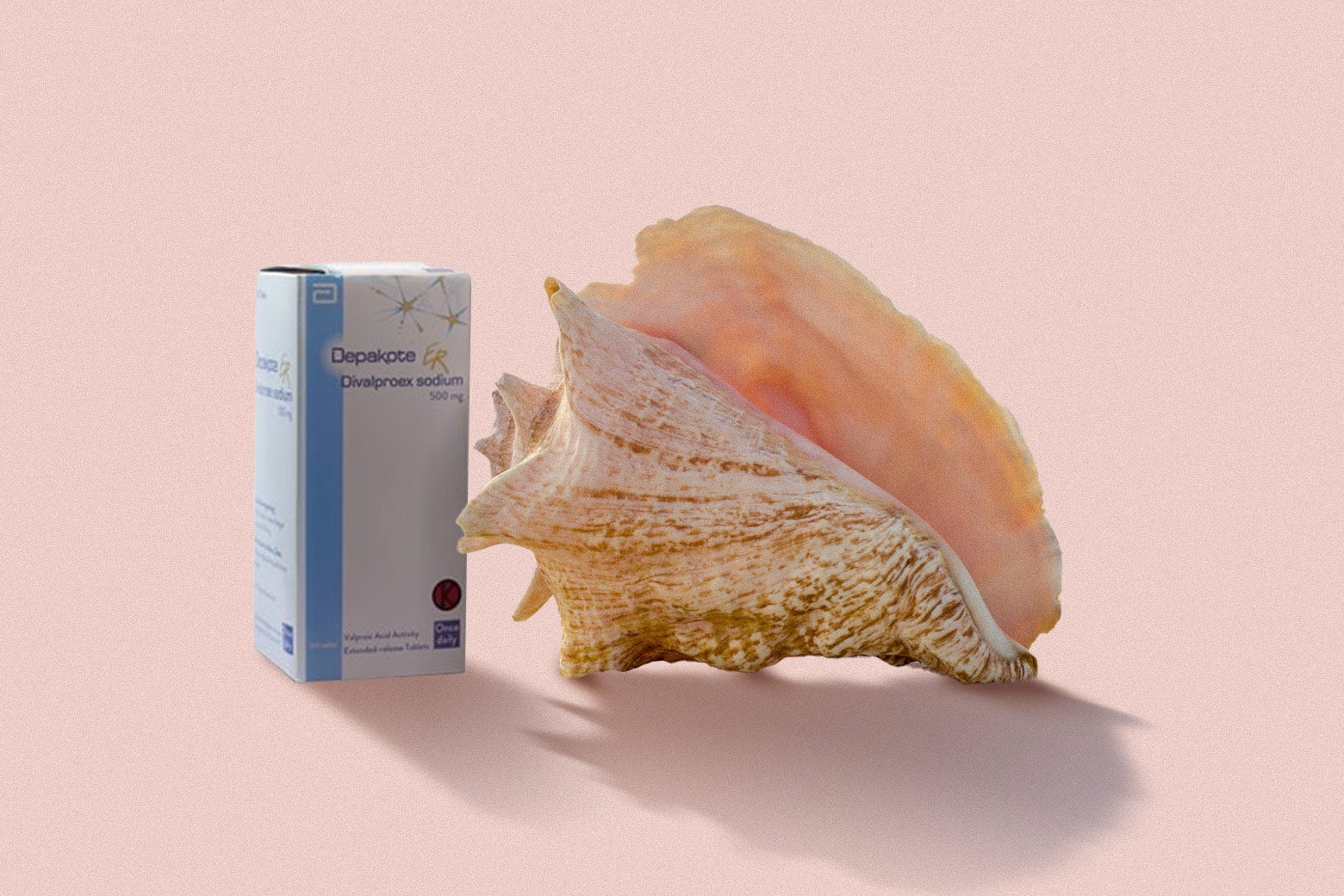 A box of the prescription medication Depakote sits beside a conch shell. 