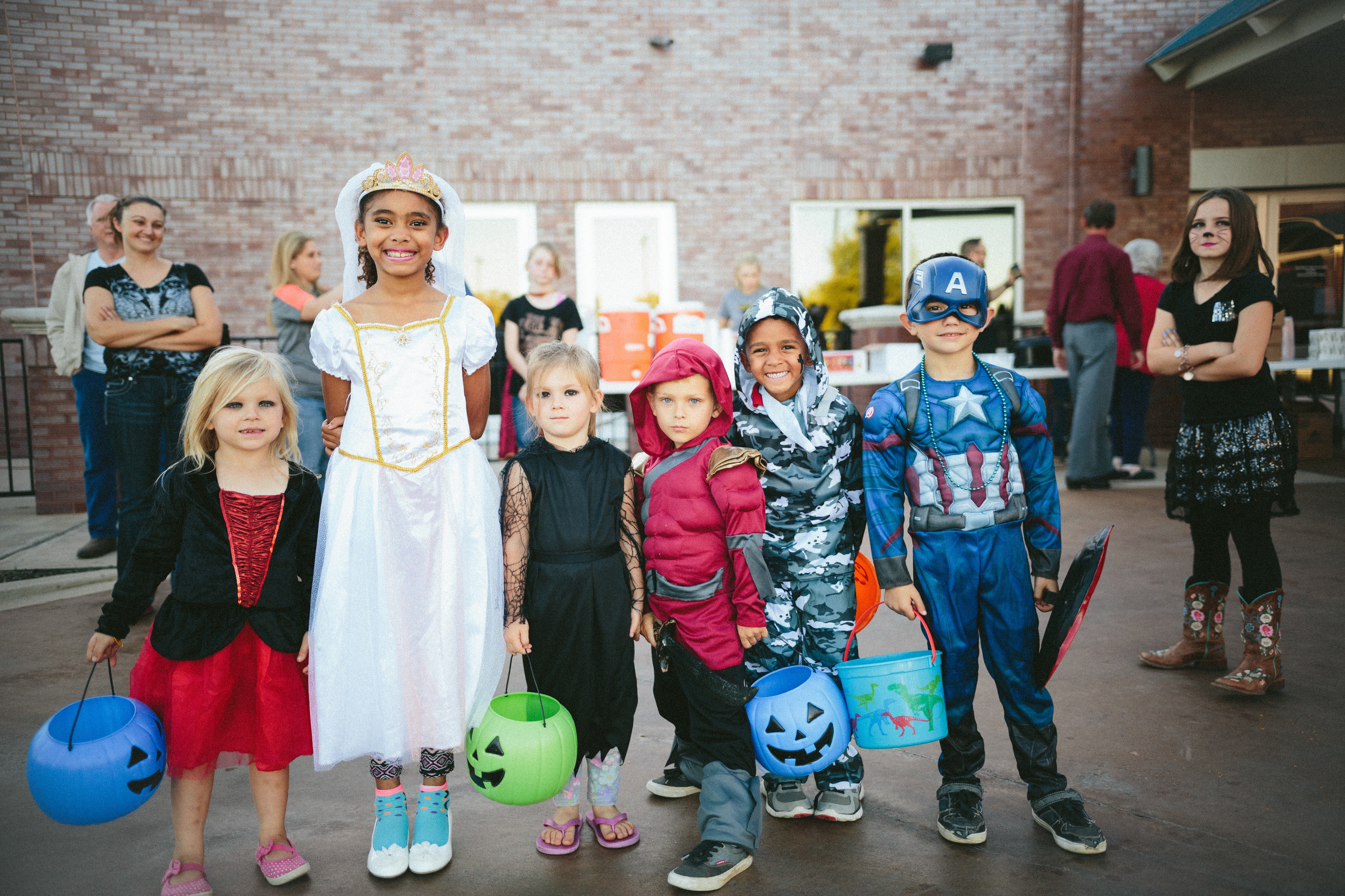 A line of kids in various Halloween costumes.