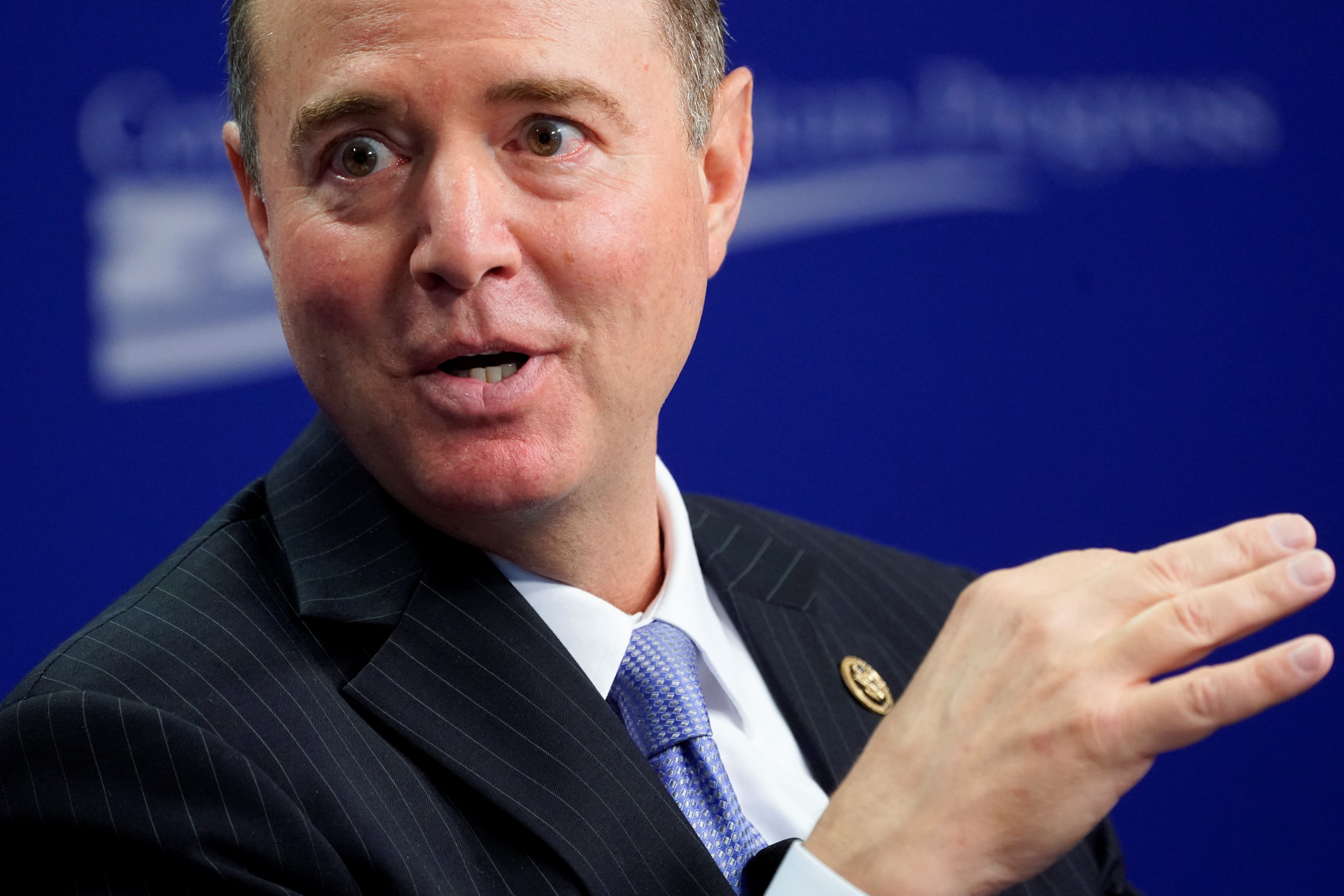 Schiff gestures with one hand as he speaks onstage