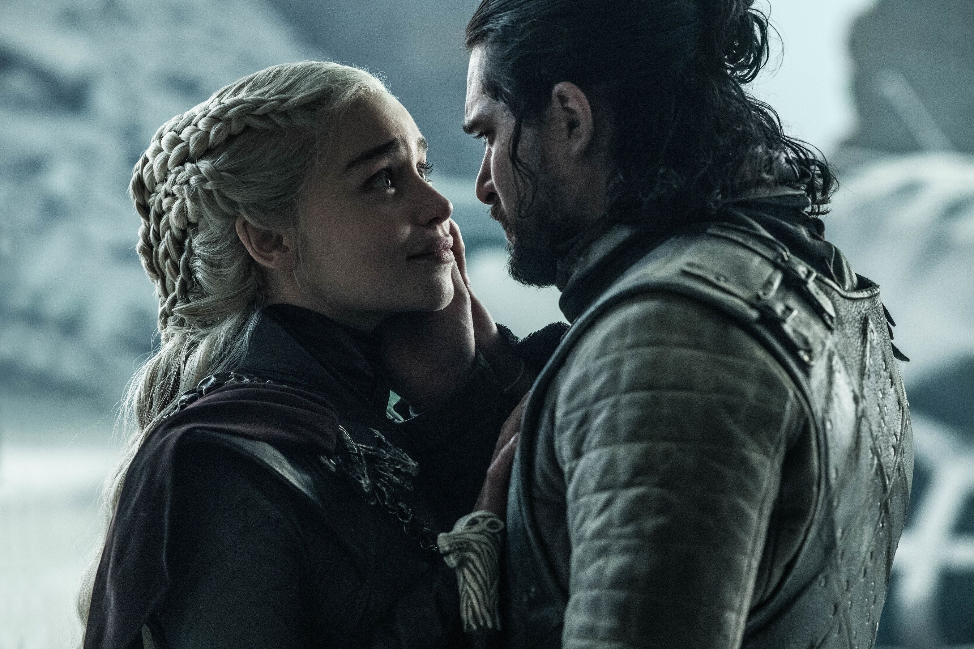 Daenerys Targaryen and Jon Snow embrace in the throne room.