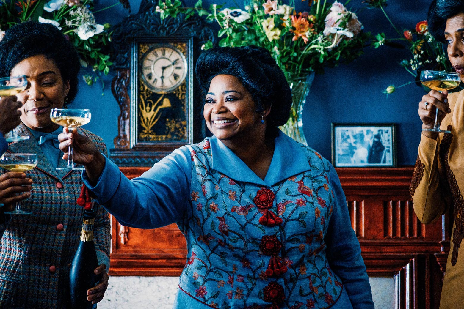 Octavia Spencer raises a cocktail to cheer with a group of women.