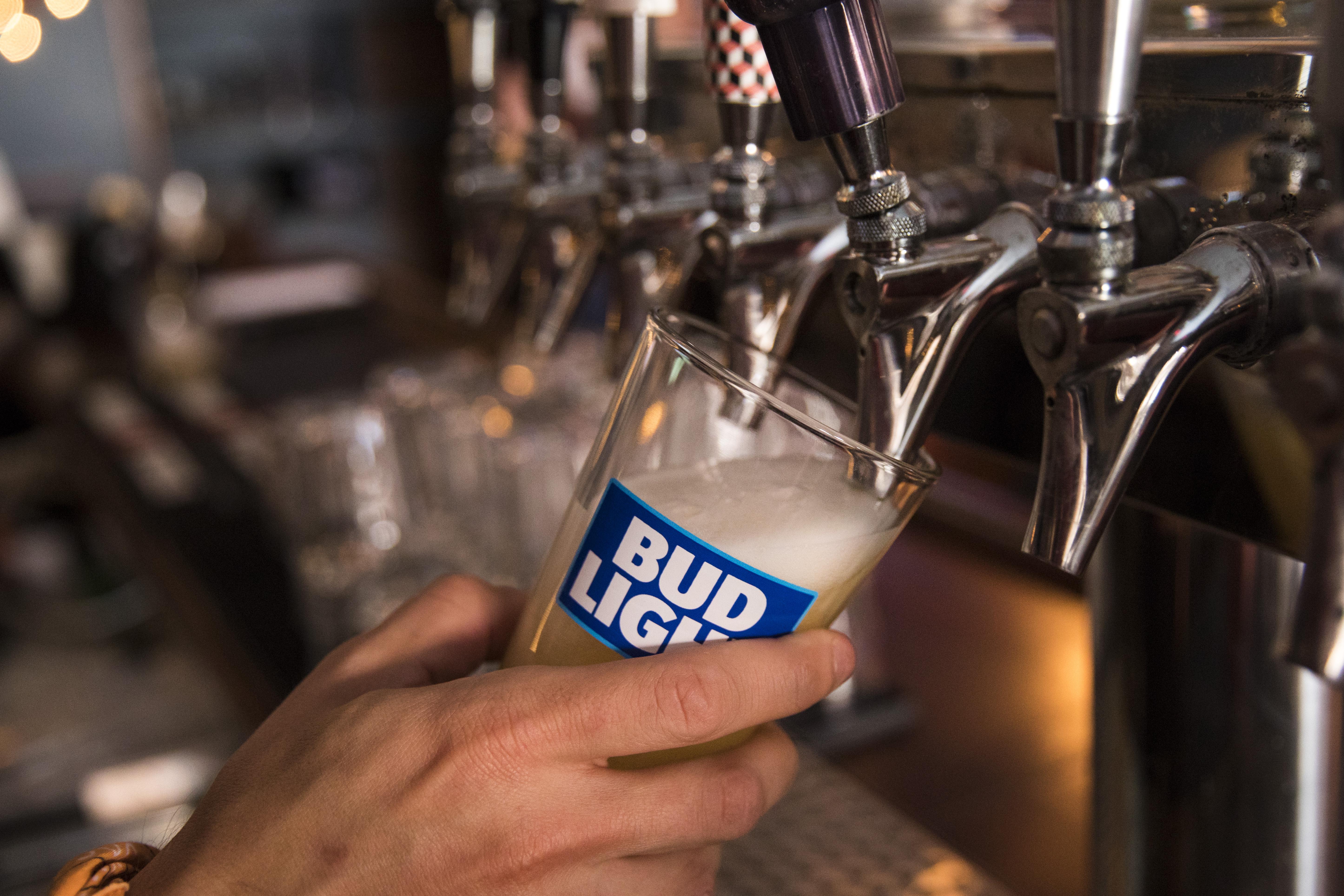 A bartender pours Bud Light from a tap.