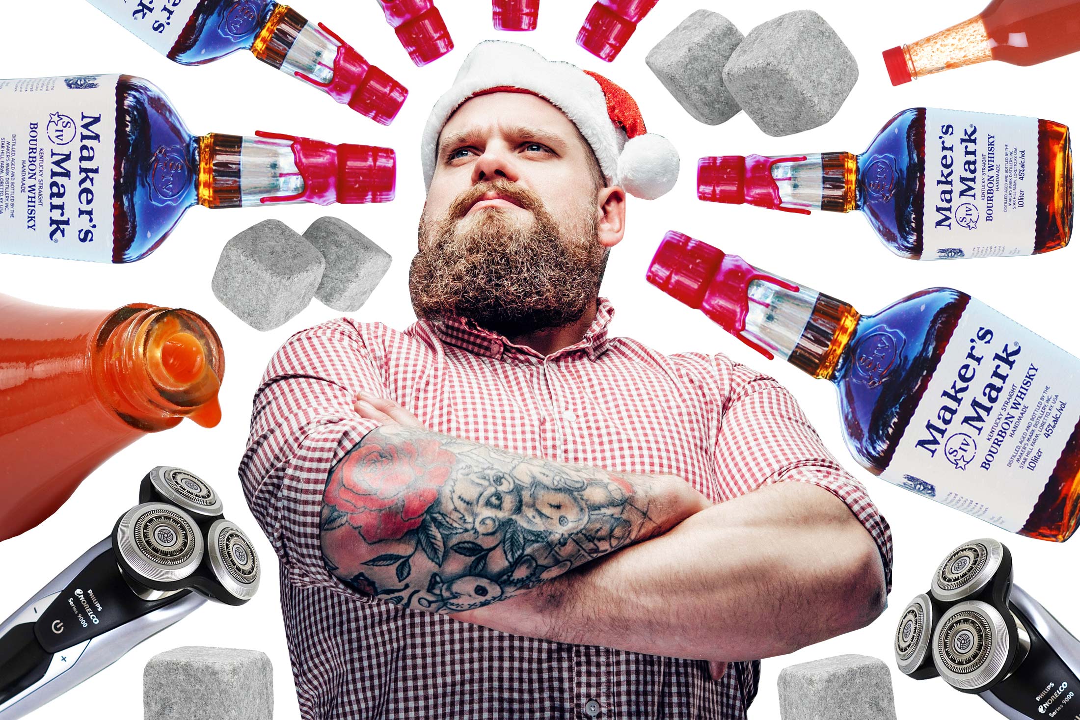 A man wearing a plaid shirt and Santa Claus hat surrounded by a mandala of whiskey hot sauce and beard trimming appliances.