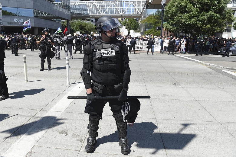 A Portland Police officer blocks the crossing of Naito Parkway during the Alt Right Rally at Tom McCall Waterfront Park on August 4, 2018 in Portland, Oregon.